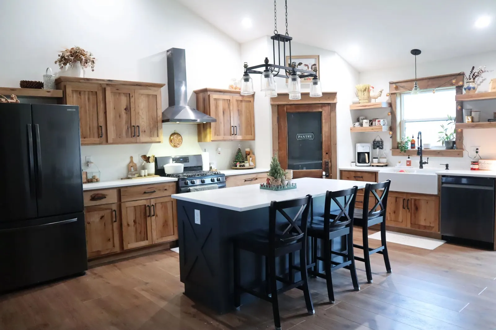 Custom Amish-built rustic hickory kitchen with a black painted island and vaulted ceiling, Wisconsin