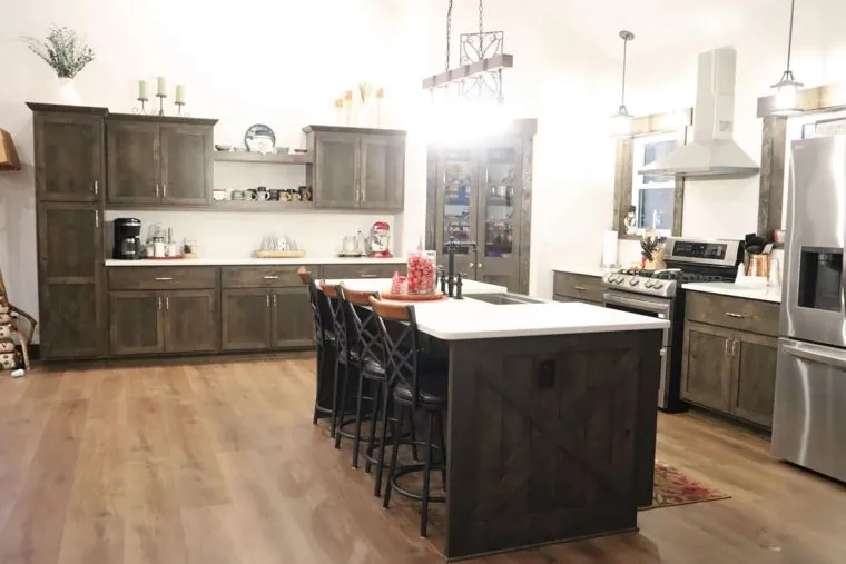Stained alder kitchen with a large island and glass-front display cabinet