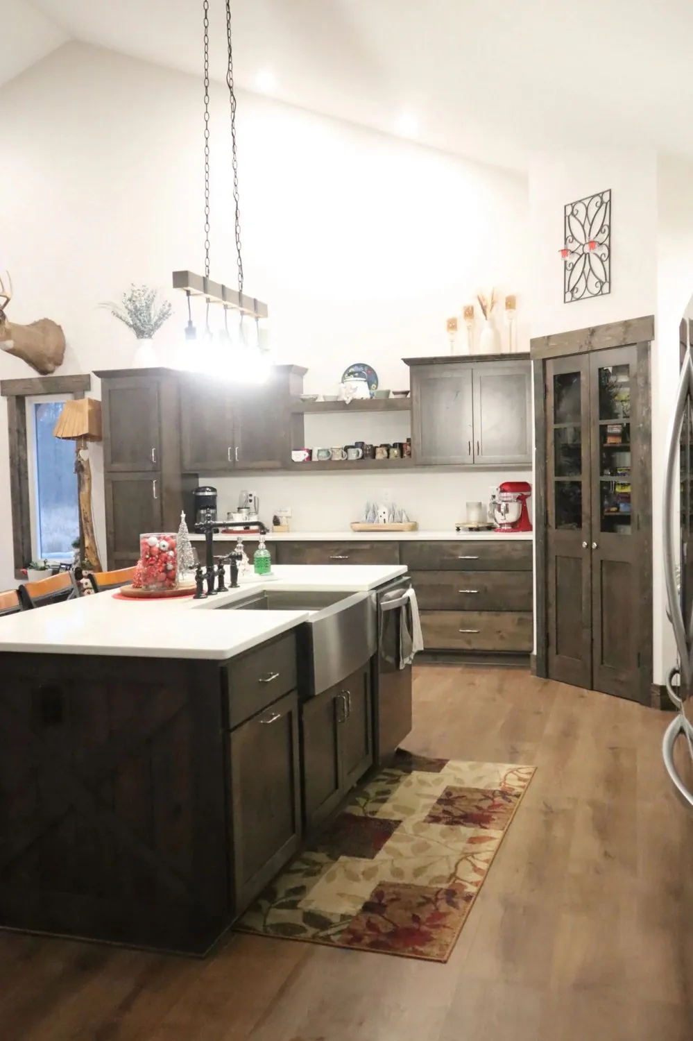 Stained alder custom kitchen cabinets with a farmhouse sink and open shelving
