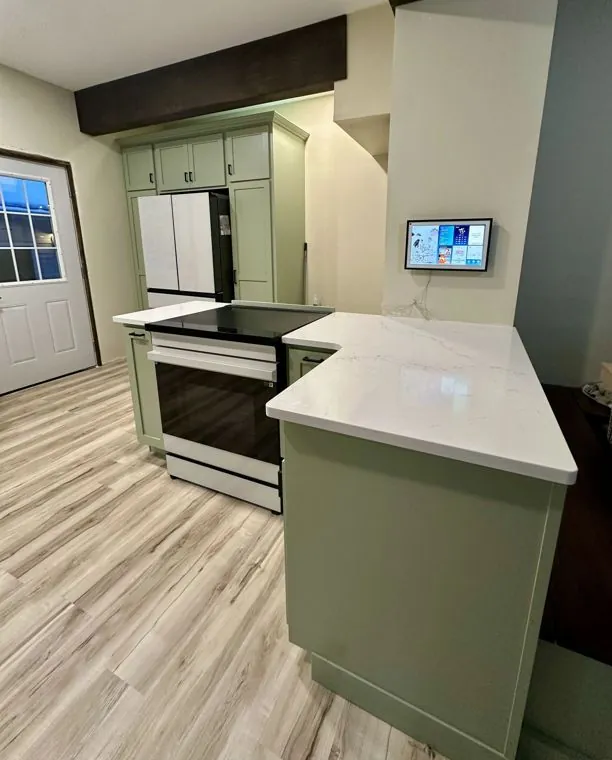 Painted maple island with a quartz top — built by Amish Heritage Woodworks, Wisconsin